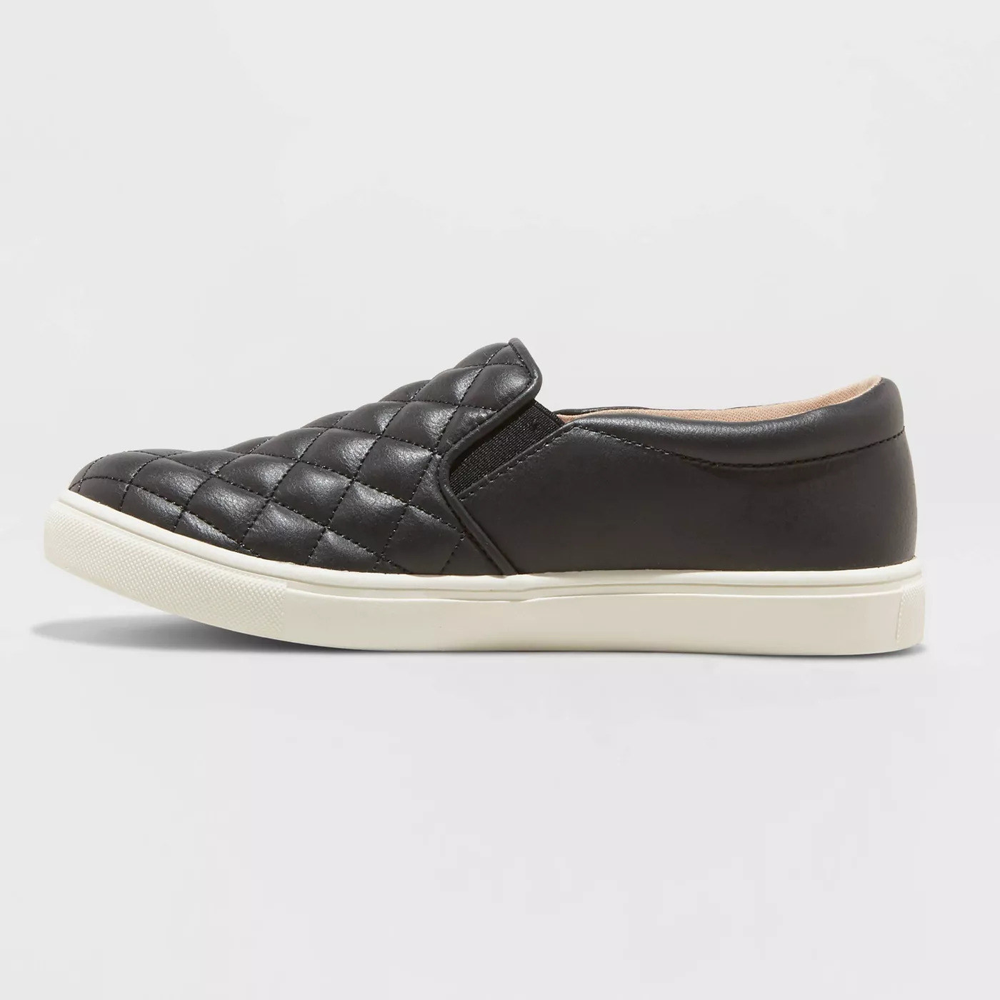 a quilted black faux leather upper with a white rubber sole