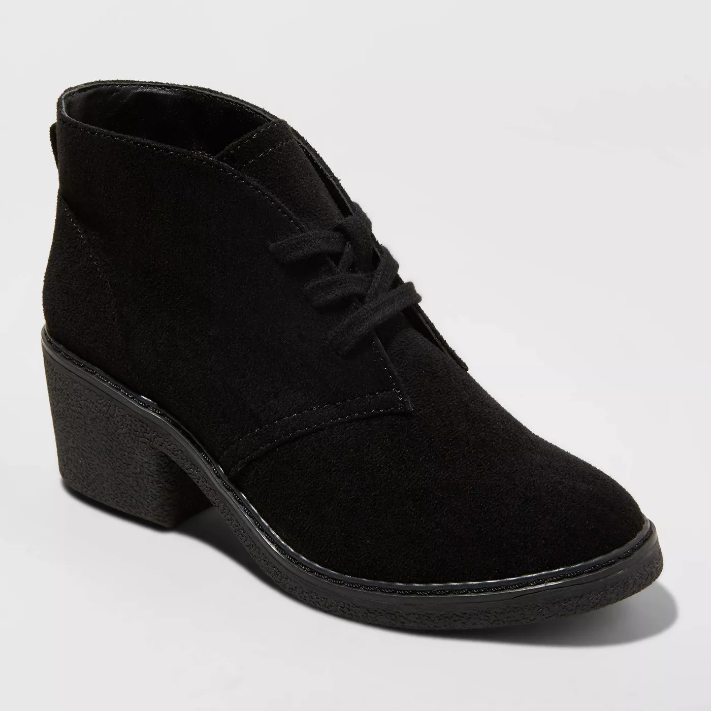 A faux suede black bootie with laces in the front, a low block heel, and a crepe sole