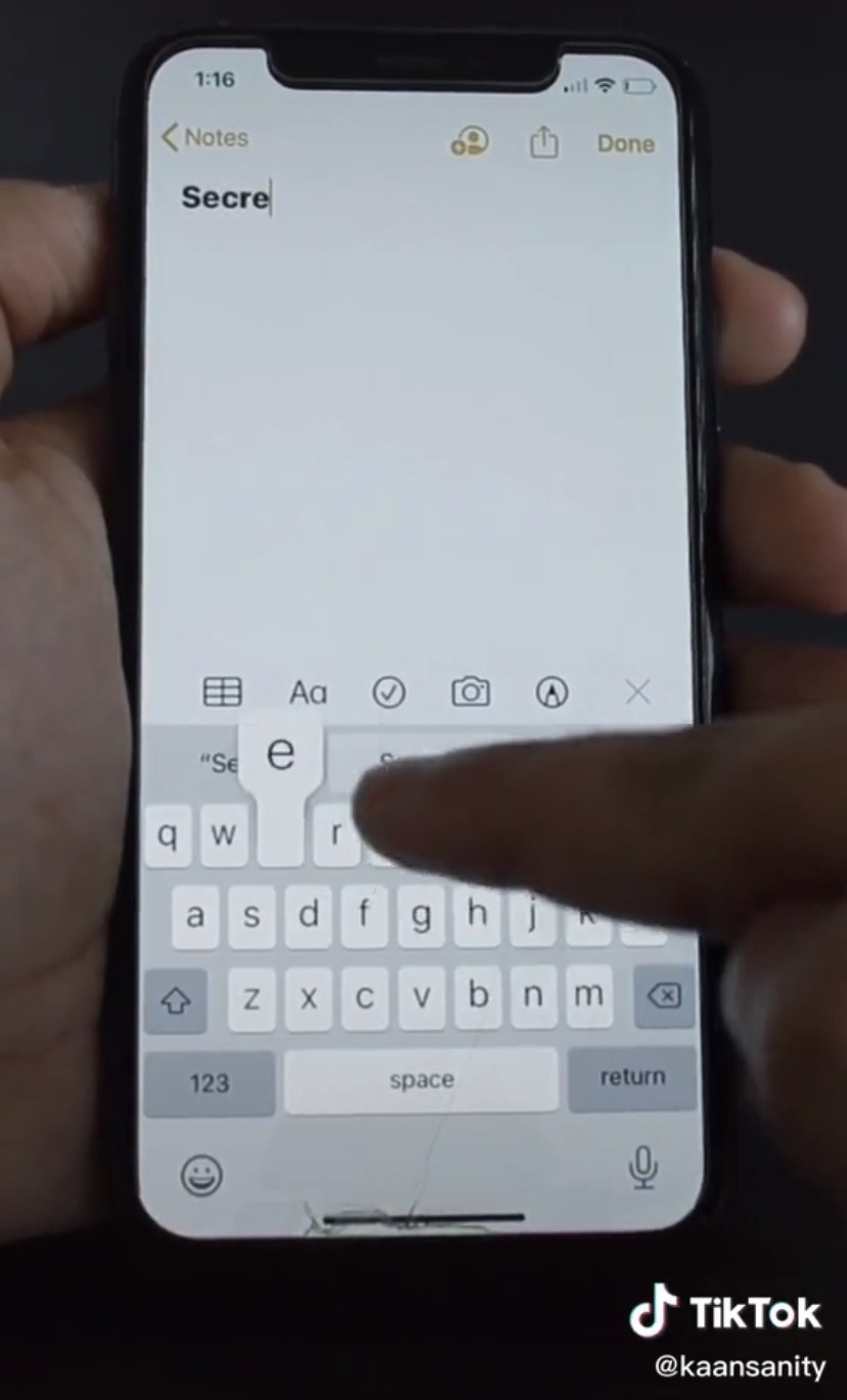Hands typing on an iPhone
