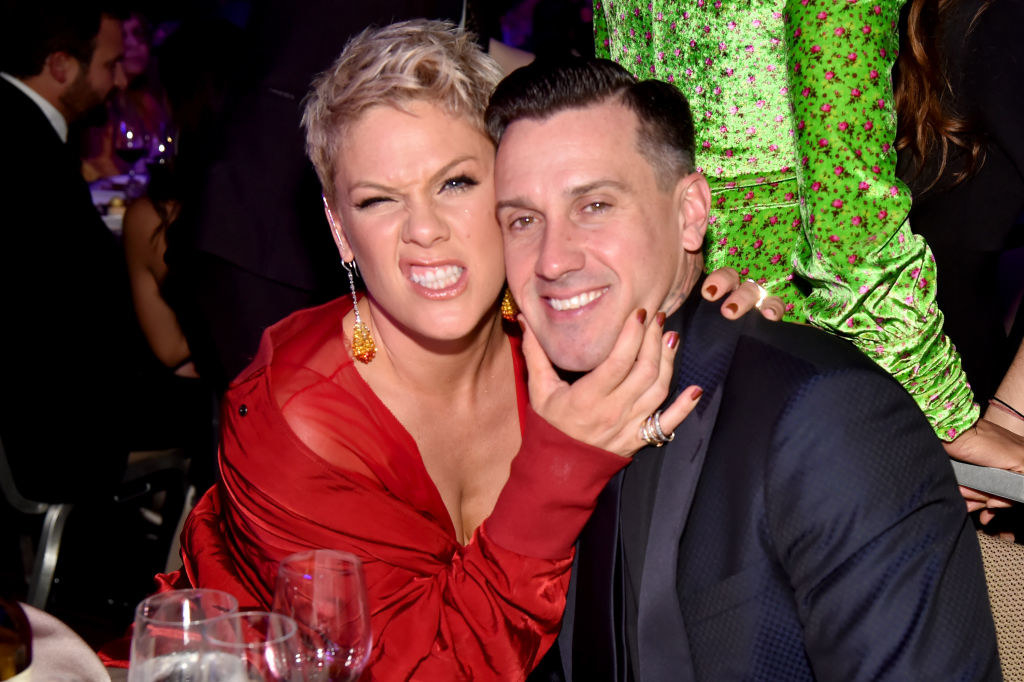 Carey Hart and Pink posing together at a Hollywood event