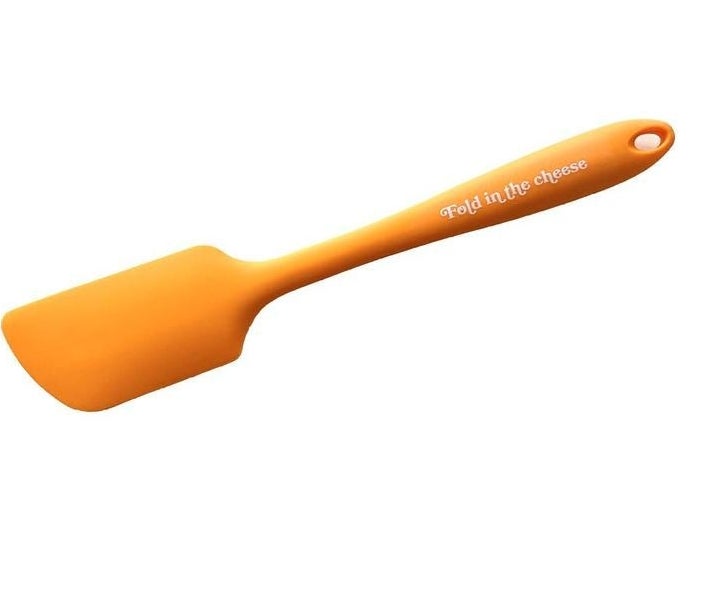 The orange spatula with the quote written on the handle