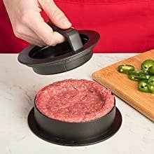 Hands using the top, handled part to make an ident in the ground beef in the bottom