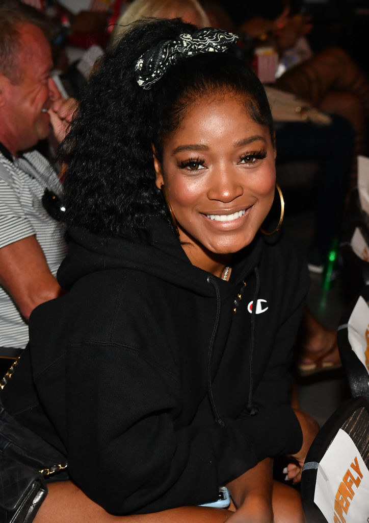 Keke smiling in a sweatshirt with her hair in a ponytail