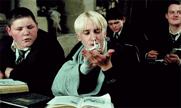 Draco blows a paper butterfly note to Harry