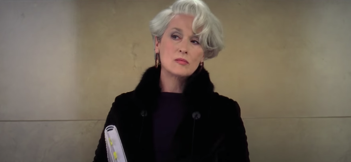 Miranda looking uninterested and unbothered in &quot;The Devil Wears Prada.&quot; 