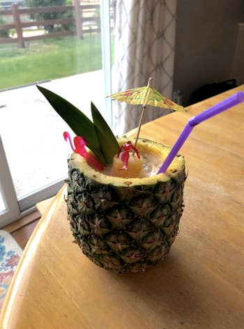 A different review image of a pina colada with the pineapple as the glass