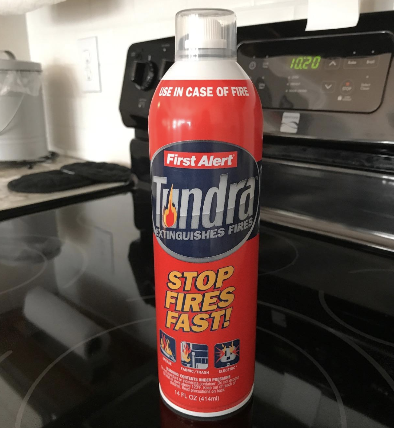 Reviewer image of a can of First Alert&#x27;s fire extinguisher sitting on top of a stove