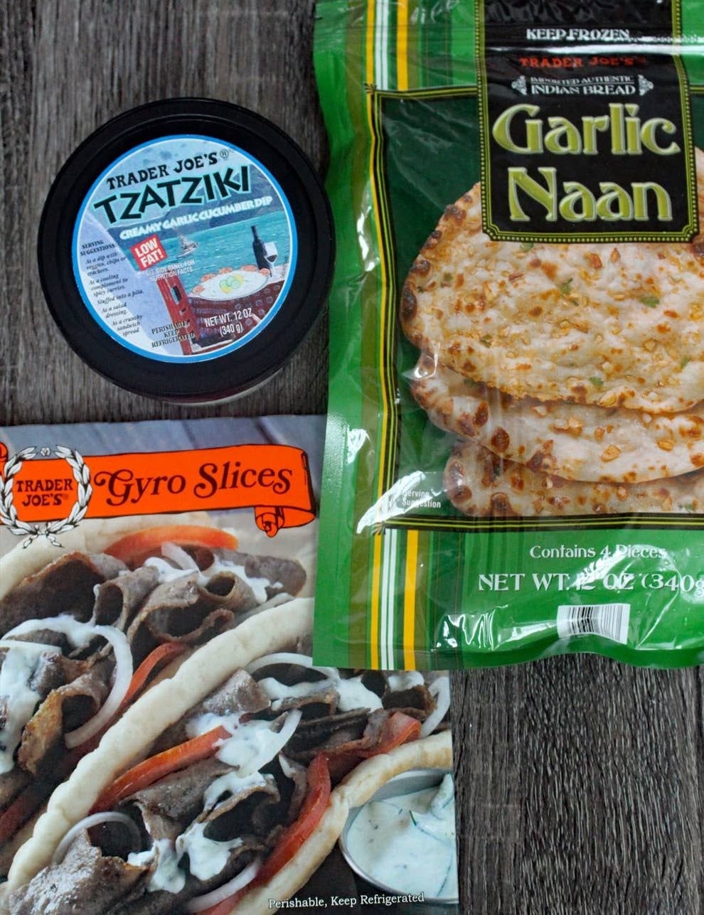 Packaged garlic naan, sliced gyro, and tzatziki on a tabletop.