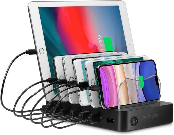 A large rectangular charing station with five phones and a tablet charging