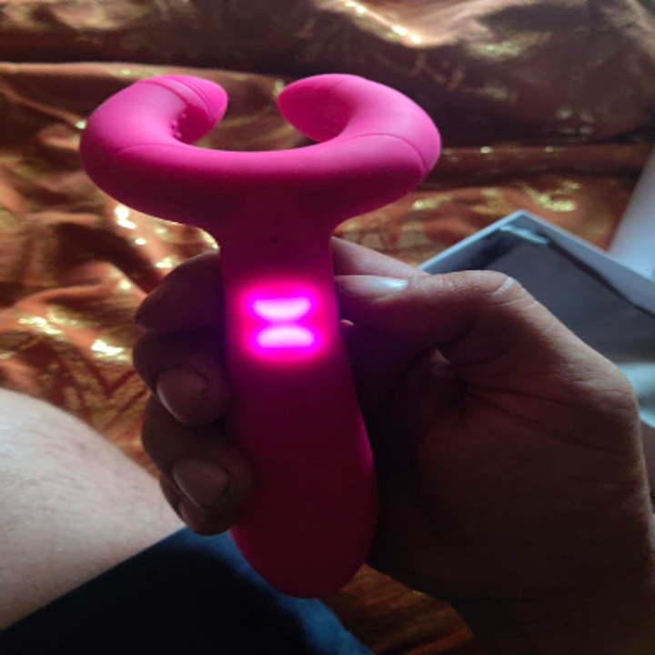 Reviewer holding the toy with the buttons glowing