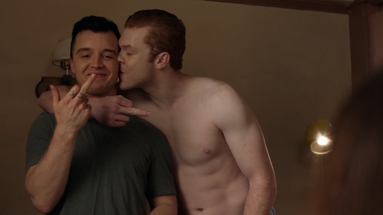 &quot;Shameless&quot; character Ian hugging and kissing Mickey while they hold up their middle fingers