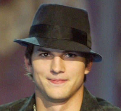 a closeup of ashton kutcher and his fedora