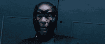 Magneto puts his hands up as the door opens