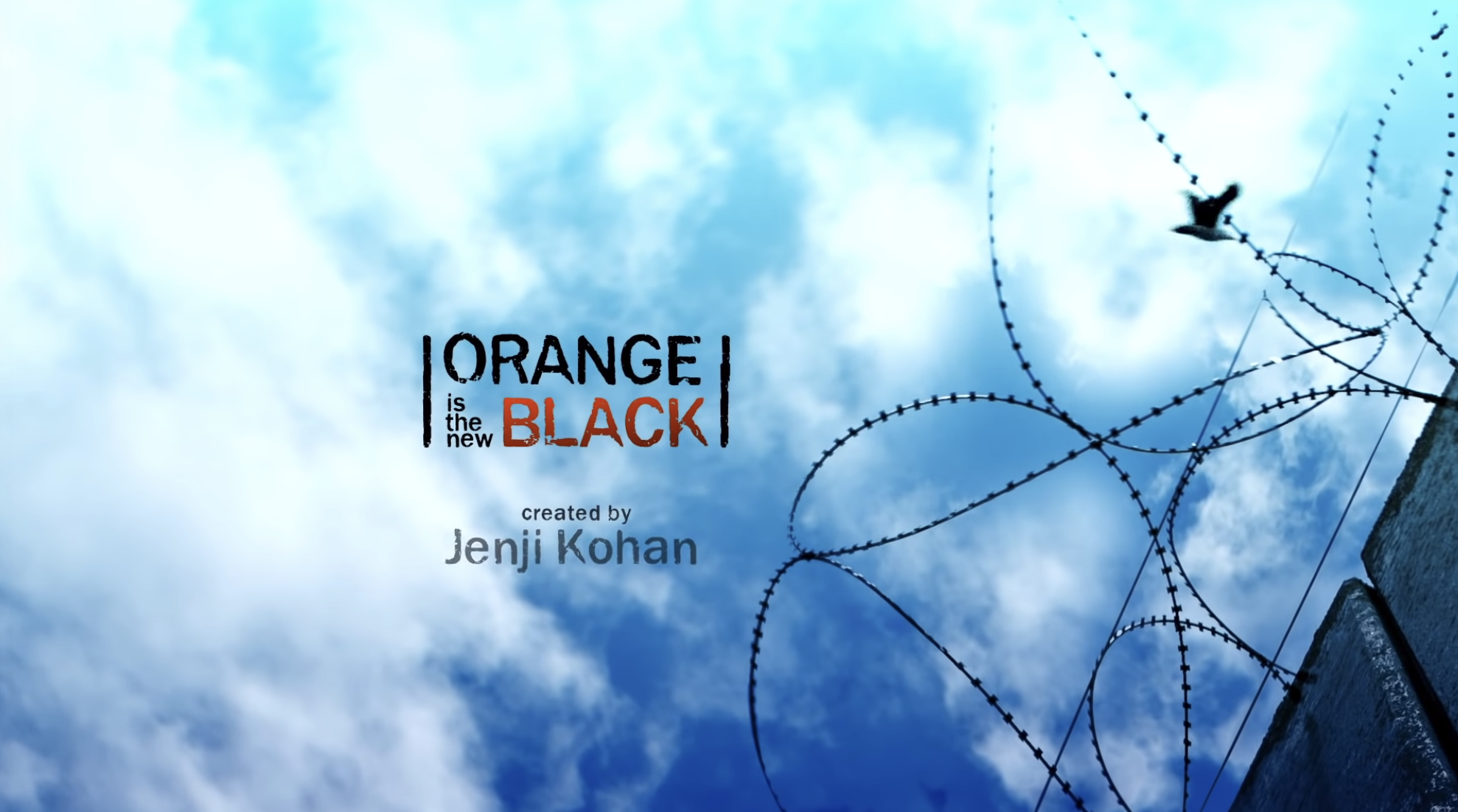 &quot;OITNB&quot; title card — which is the title in the sky over a prison yard. 