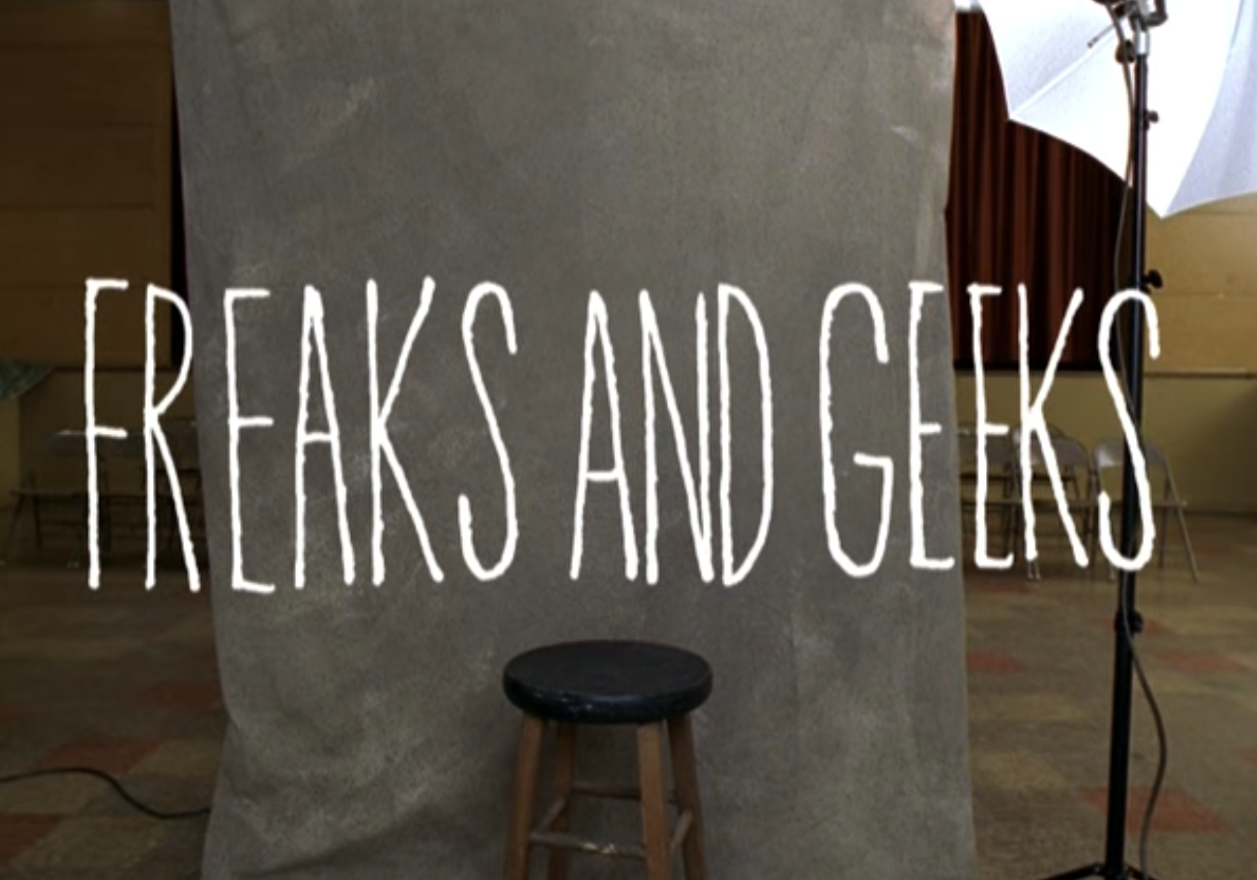 &quot;Freaks and Geeks&quot; title card — which is the title over a school picture day backdrop. 