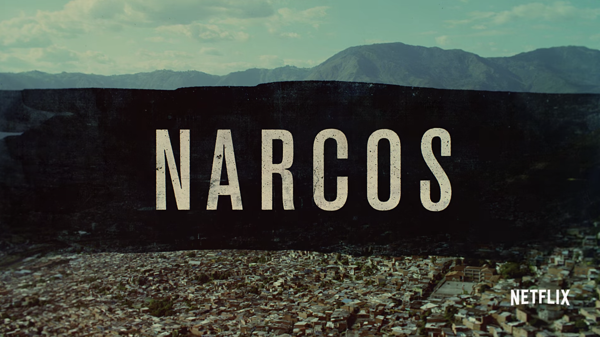 &quot;Narcos&quot; title card — which is the title over a landscape of Colombia. 