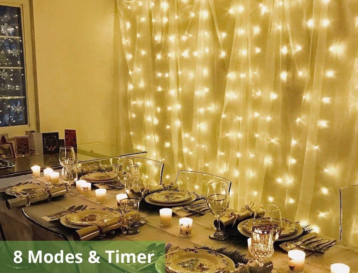 Fairy lights hung upon a wall beside a dinner table