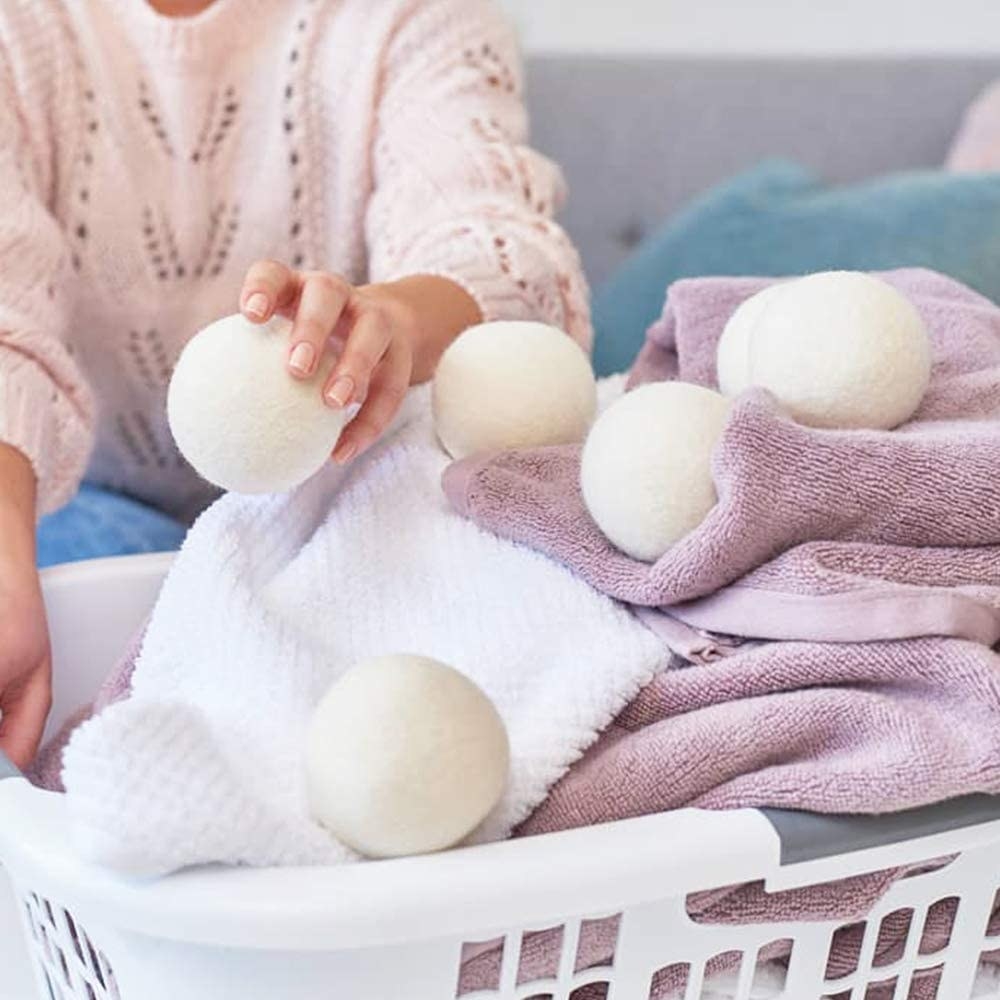 The dryer balls being added to laundry