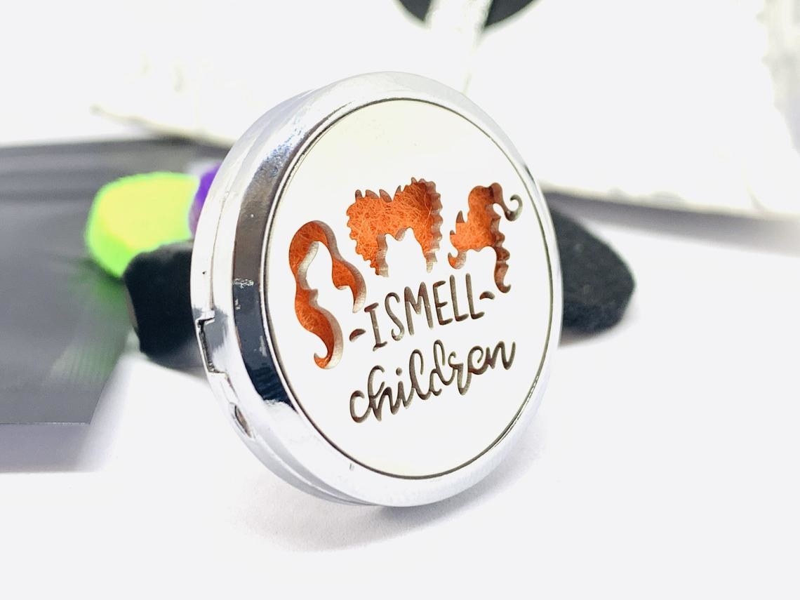 silhouettes of the main characters hair and the words &quot;i smell children&quot; on disc holding type of air freshenr  