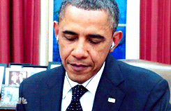Obama listening to music through his headphones. 