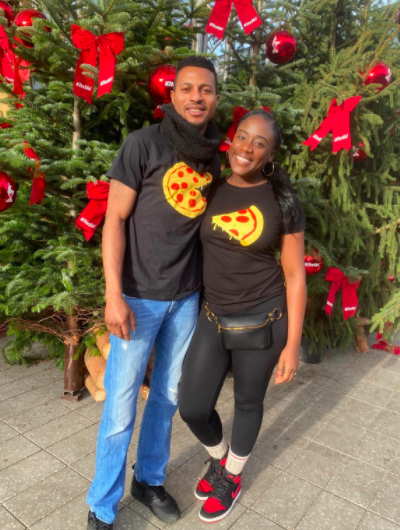 Couple wears matching pizza shirts: One with a pie and one with a slice, while spending time outdoors