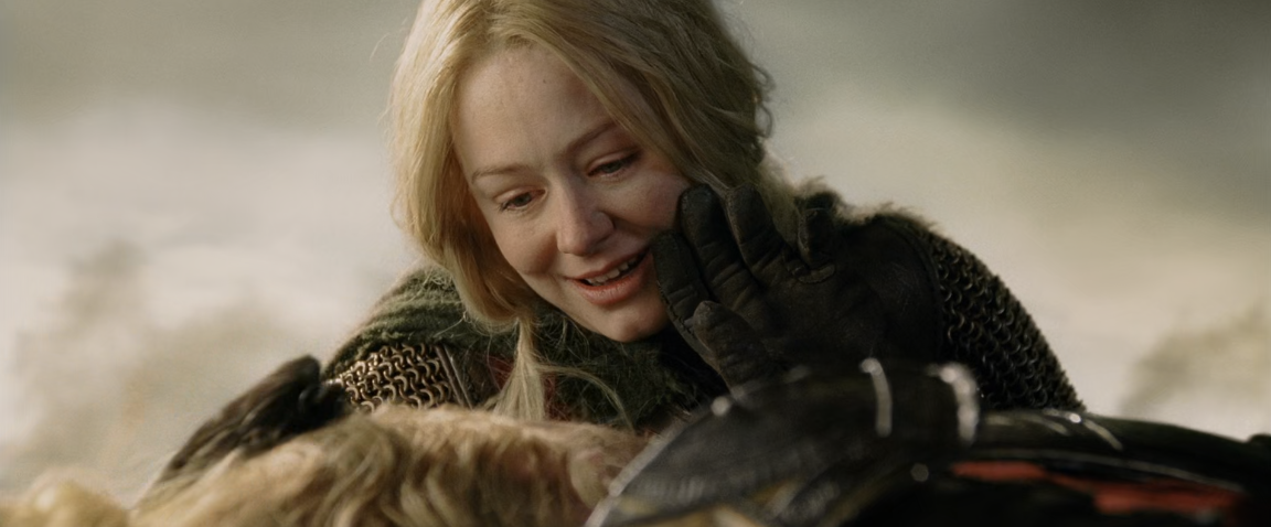 Éowyn looking at Théoden, who is lying on the ground