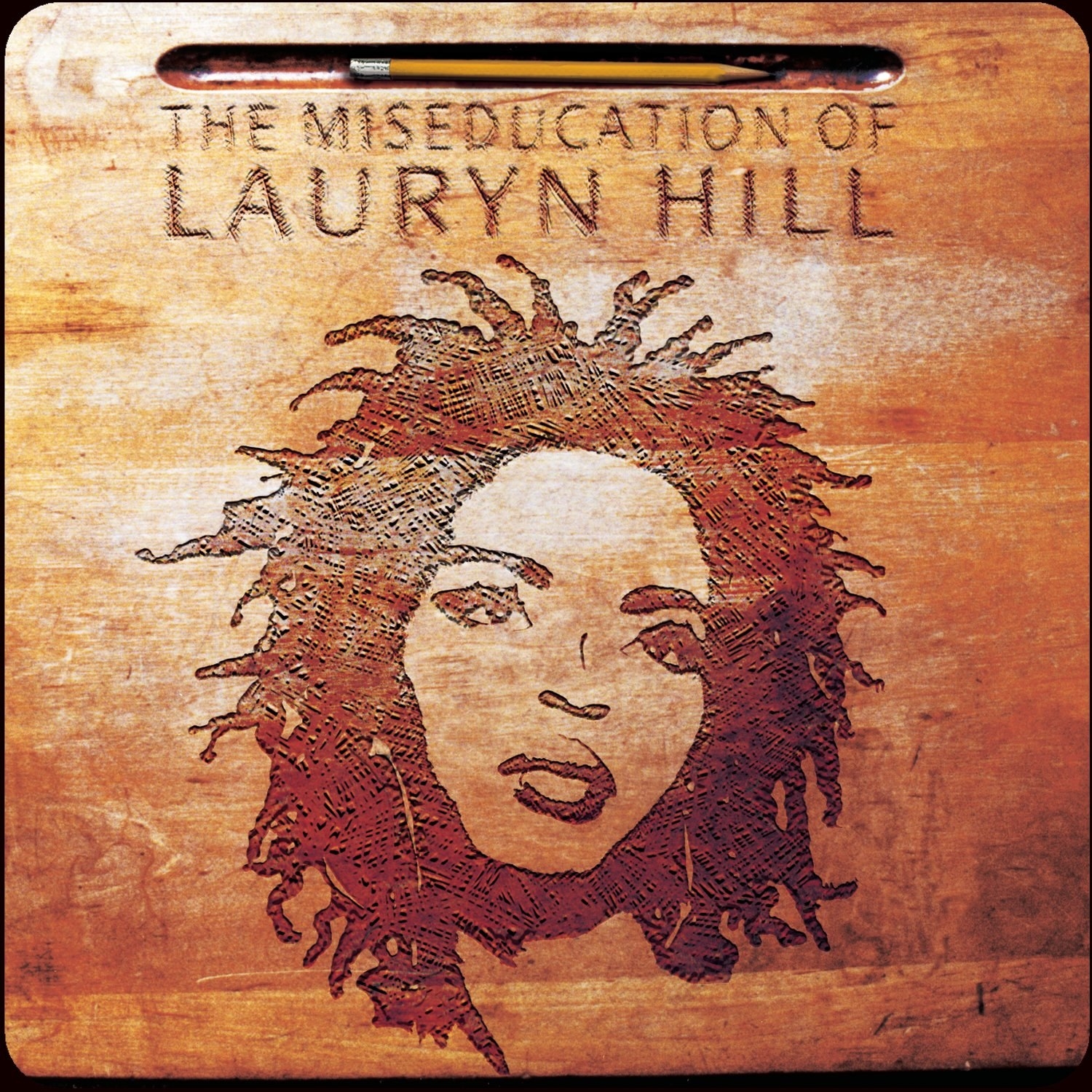 Portrait of Ms. Lauryn Hill etched into an old school wooden desk top. 