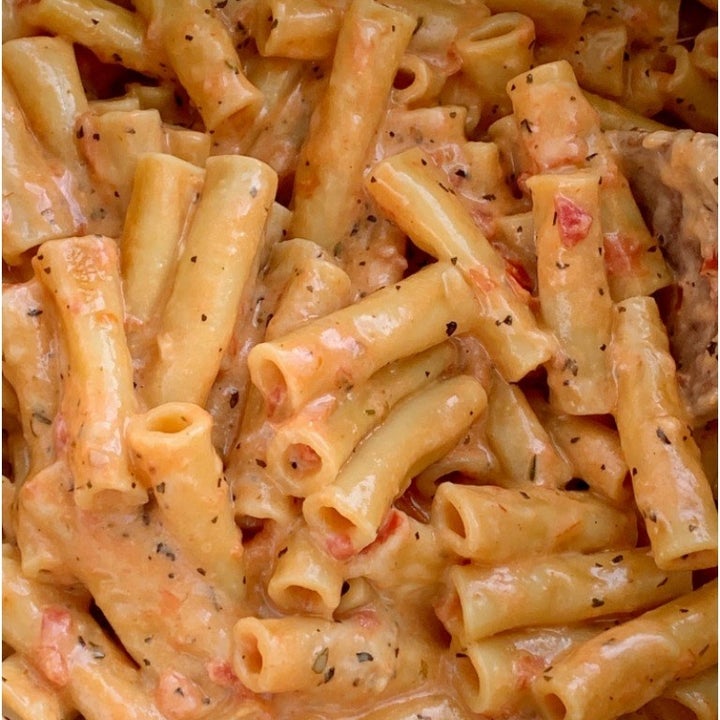 A close-up shot of cheesy, creamy baked ziti.