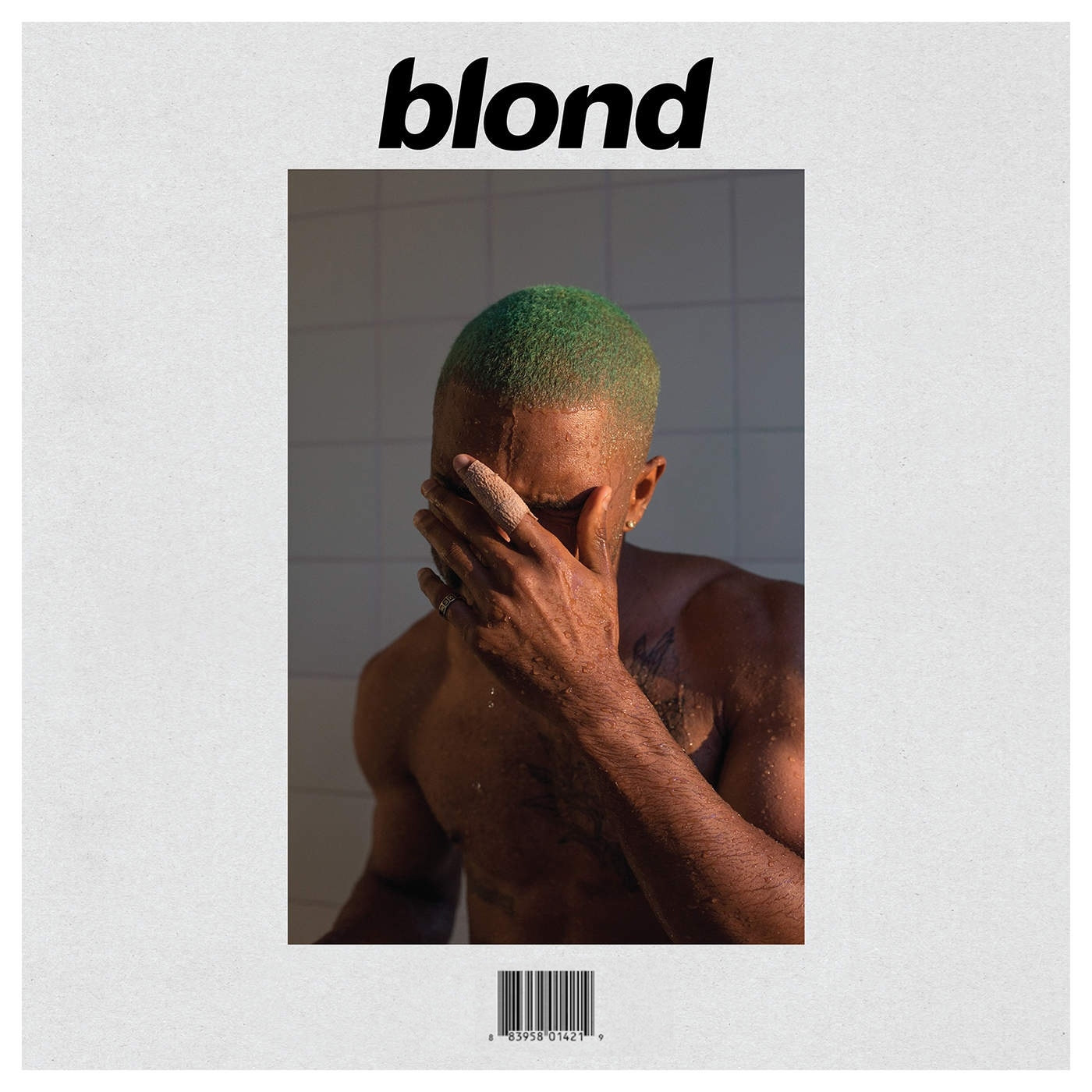 Frank Ocean, covering his face in the shower, with a green buzzcut. 