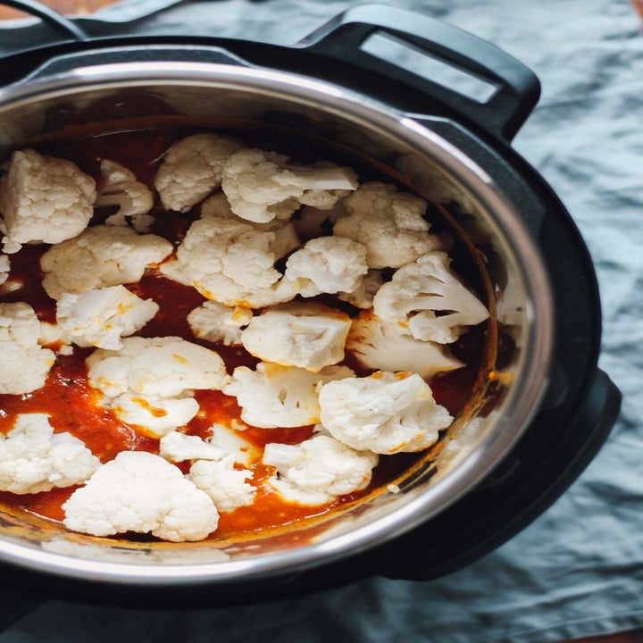 Uncooked cauliflower just poured into the Instant Pot on top of tikka masala sauce.