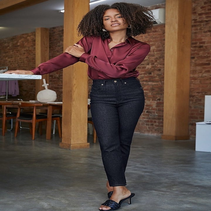 A model in a burgundy satin shirt