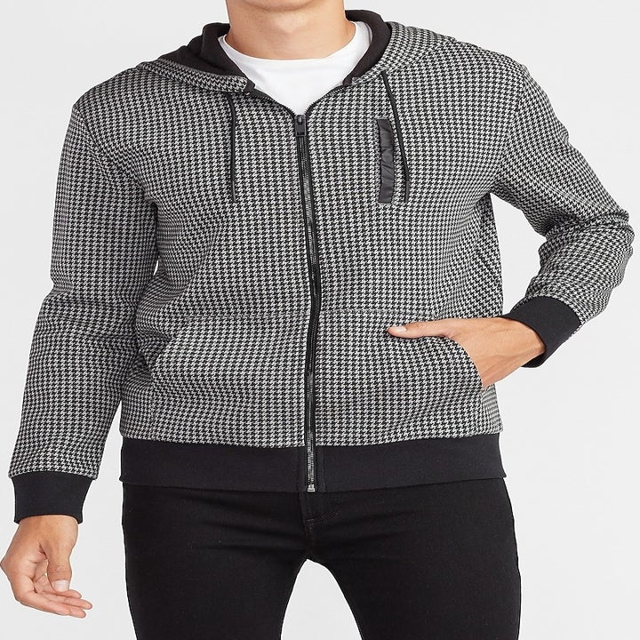 A model in a houndstooth zip-up hoodie