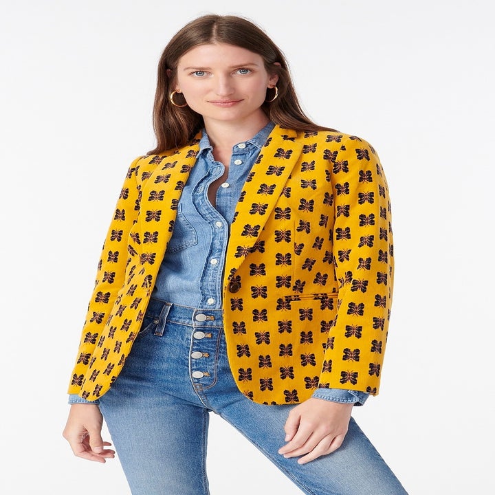 A model in the yellow butterfly print blazer