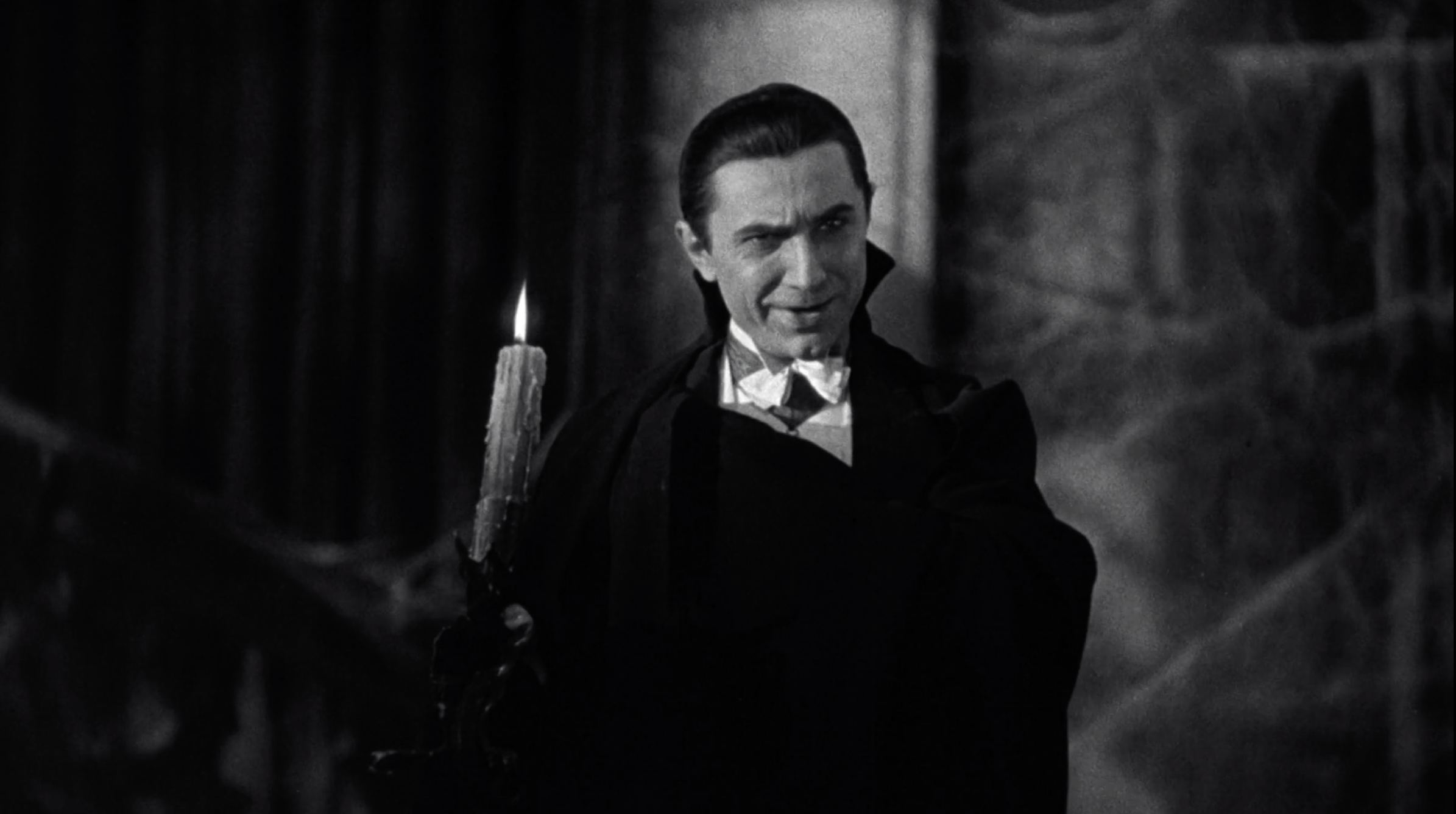 Bela Lugosi holding a candle in the 1931 version of Dracula 