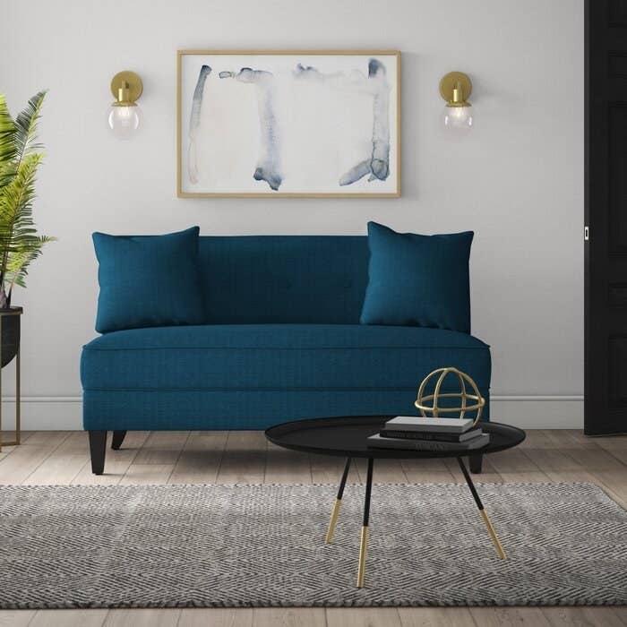 The teal loveseat