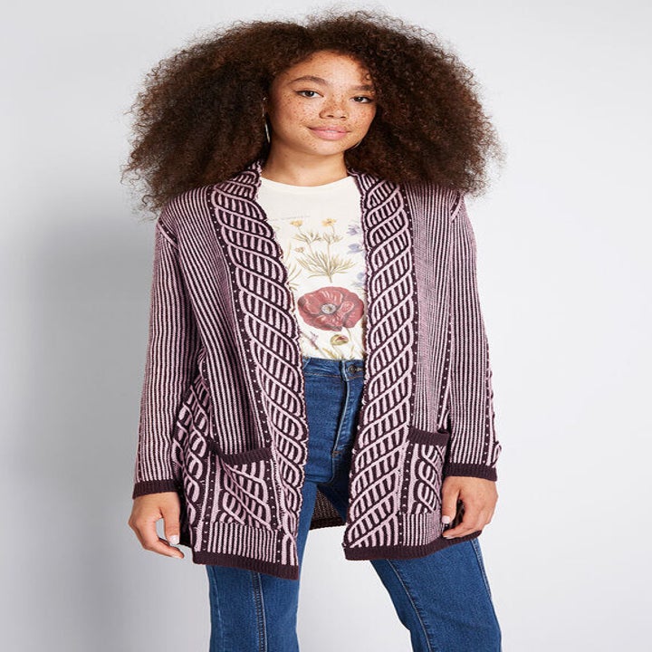 A model in the purple rope-stitch open cardigan