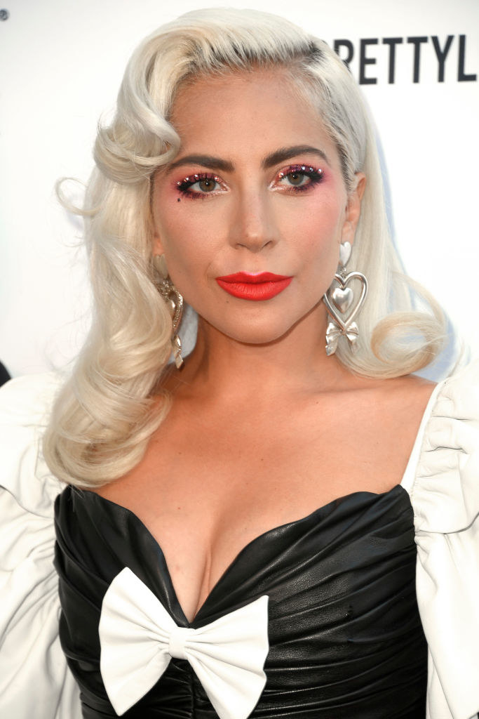 Lady Gaga wearing a dress with a box and makeup with rhinestones