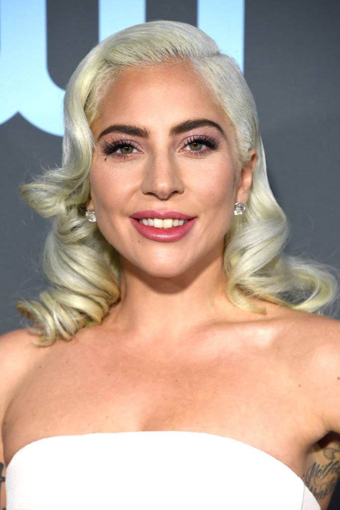 Lady Gaga smiling with her hair curled