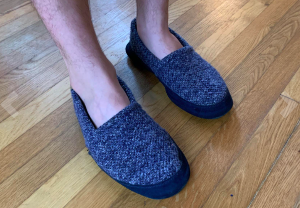 Reviewer photo showing person wearing the Acorn Men's slippers in navy tweed