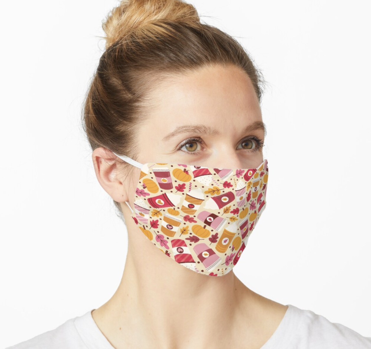 Model in a face mask with cartoon coffee cups, leaves, and pumpkins on it