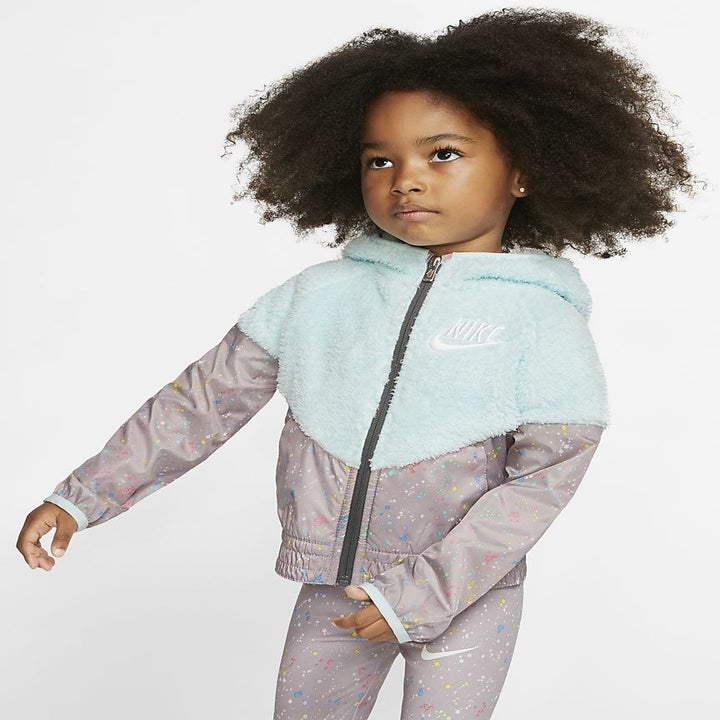 A kid in the fleece and patterned sherpa windbreaker