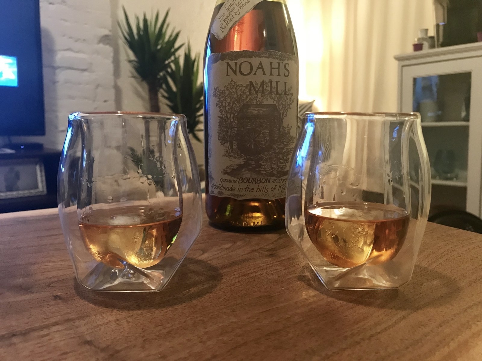 A bottle and two glasses of Noah&#x27;s Mill bourbon