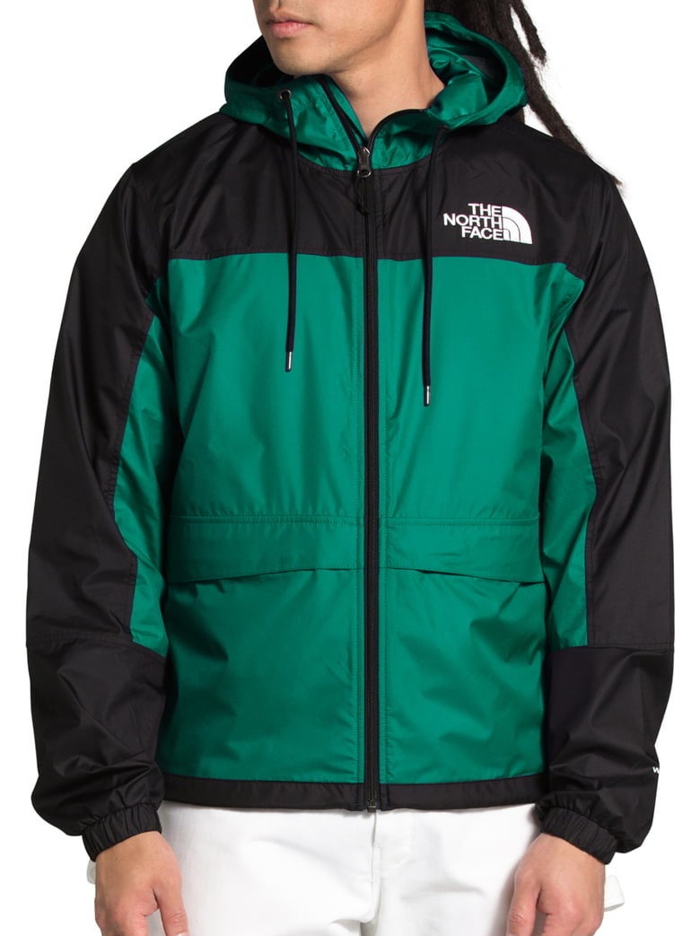Model wearing The North Face HMLYN wind breaker in evergreen