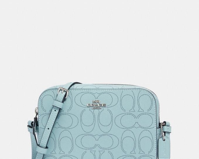 A light blue crossbody bag perforated with the C logo pattern