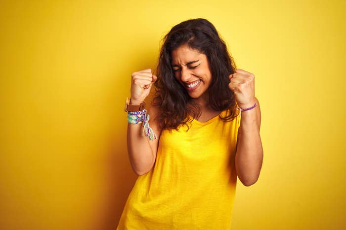 An excited woman makes two fist pumps