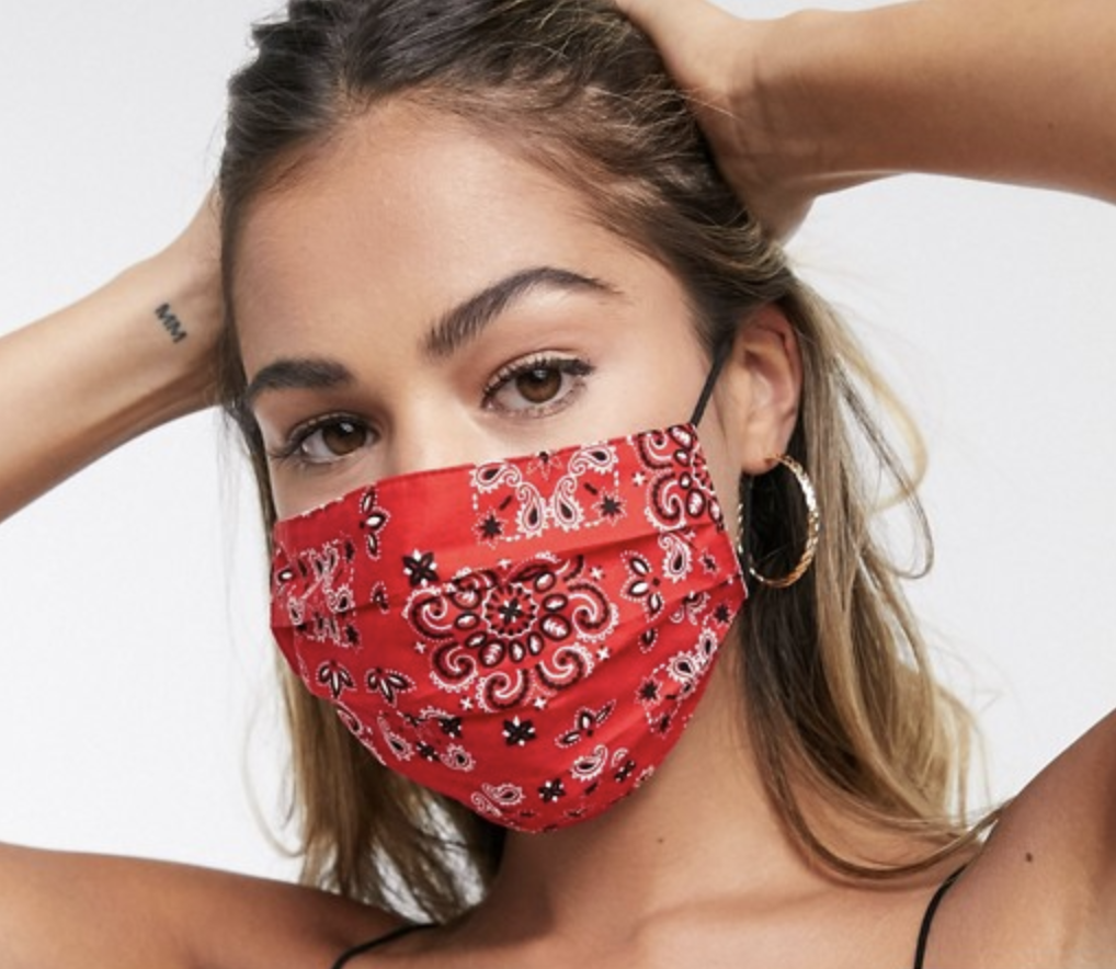 Model in a red bandana print face mask 