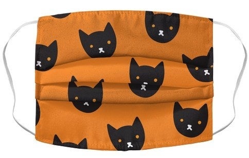 orange mask with cartoon black cat faces 