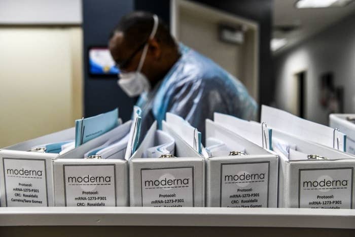 Several binders containing the Moderna vaccine trial protocols