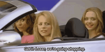 A GIF of someone in the front seat of a car saying get in loser we&#x27;re going shopping