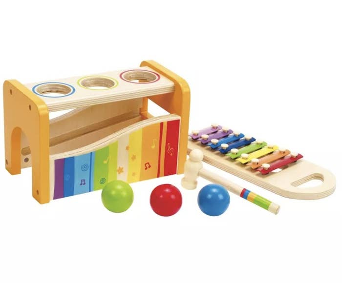 A colorful tap and pound bench with three balls that can be hit with a hammer onto a xylophone